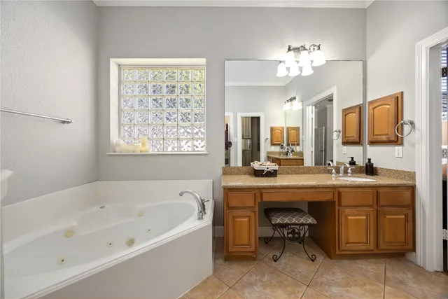 a spacious bathroom with a bathtub and a sink