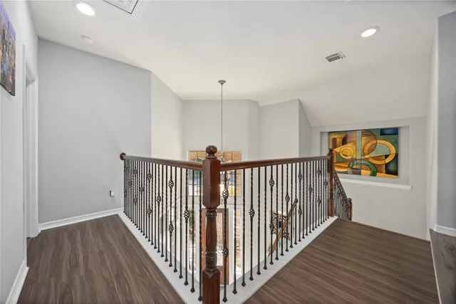 a view of hallway with wooden floor
