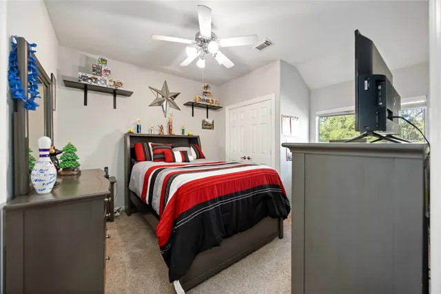 a bed room with a bed and a television