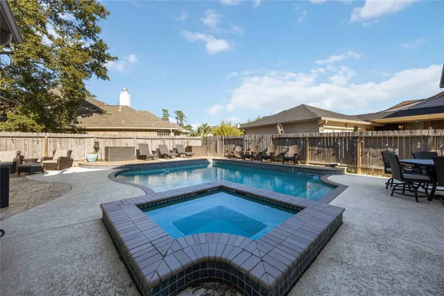 a view of a swimming pool with lounge chair
