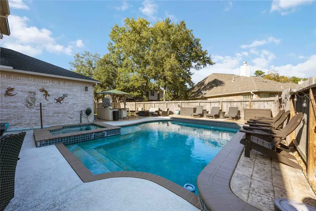 a view of a patio with swimming pool table and chairs