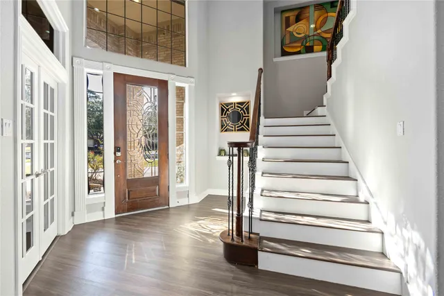a view of an entryway with wooden floor and door