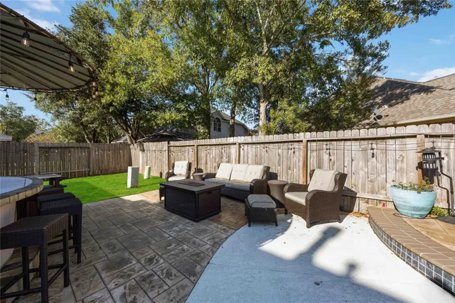 a view of a house with a backyard and a patio