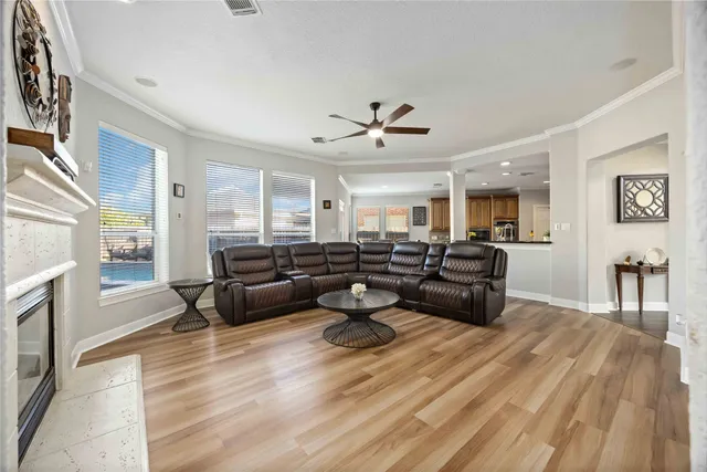 a living room with furniture and a wooden floor