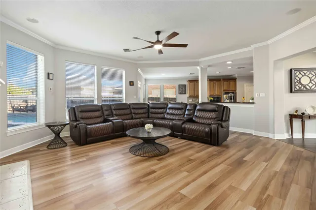 a living room with furniture and wooden floor