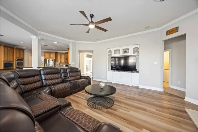 a living room with furniture and a wooden floor