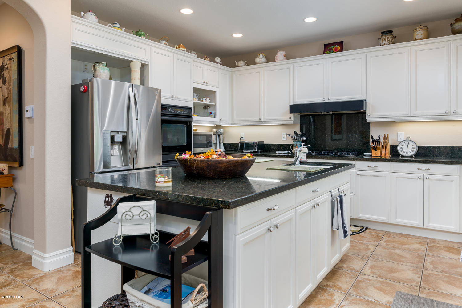 161 Laurel Ridge Drive Simi Valley, CA 93065 - Photo 22 of 50 a kitchen with stainless steel appliances granite countertop a refrigerator a sink dishwasher a stove and white cabinets with wooden floor