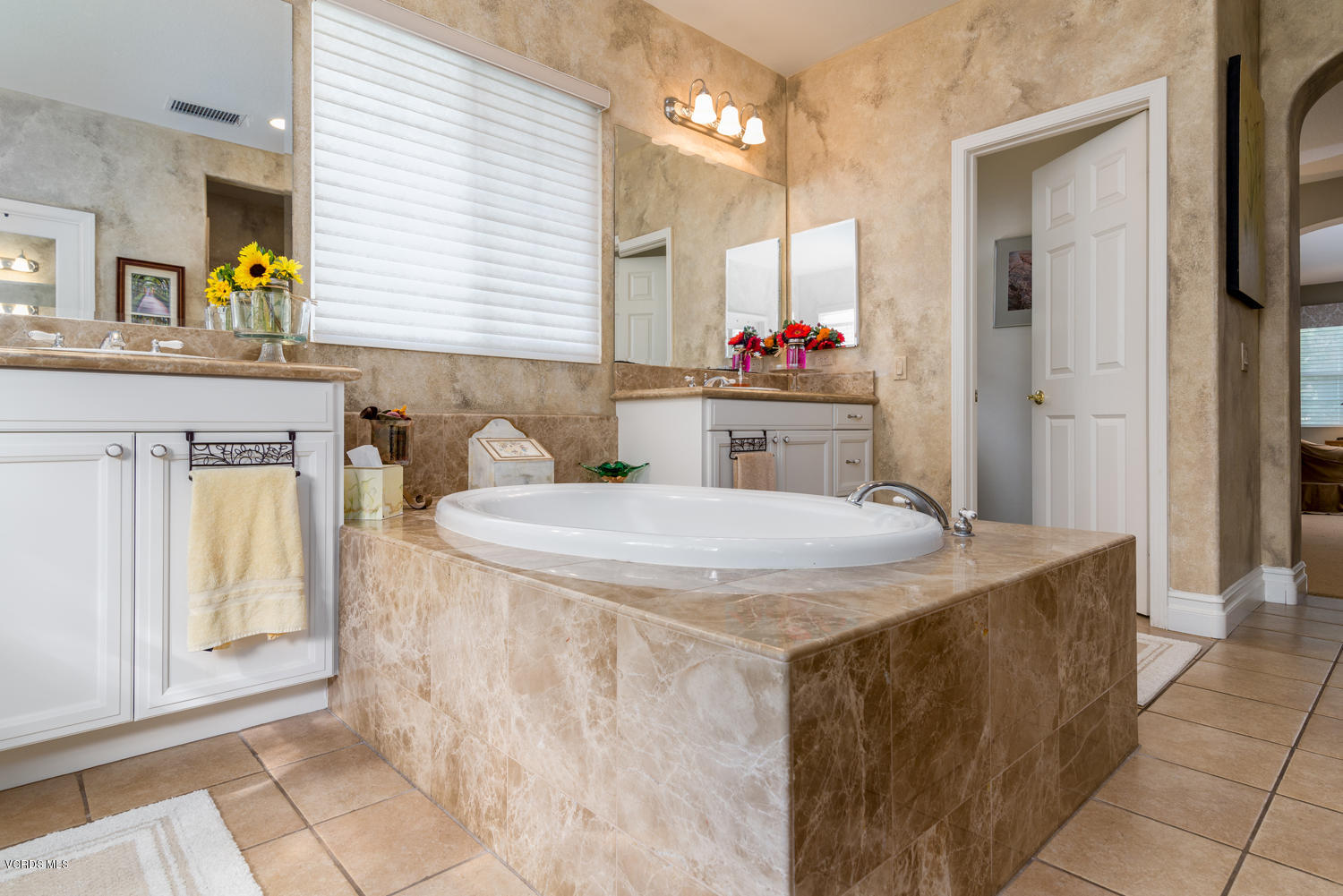 161 Laurel Ridge Drive Simi Valley, CA 93065 - Photo 32 of 50 a bathroom with a granite countertop sink a mirror and a bathtub