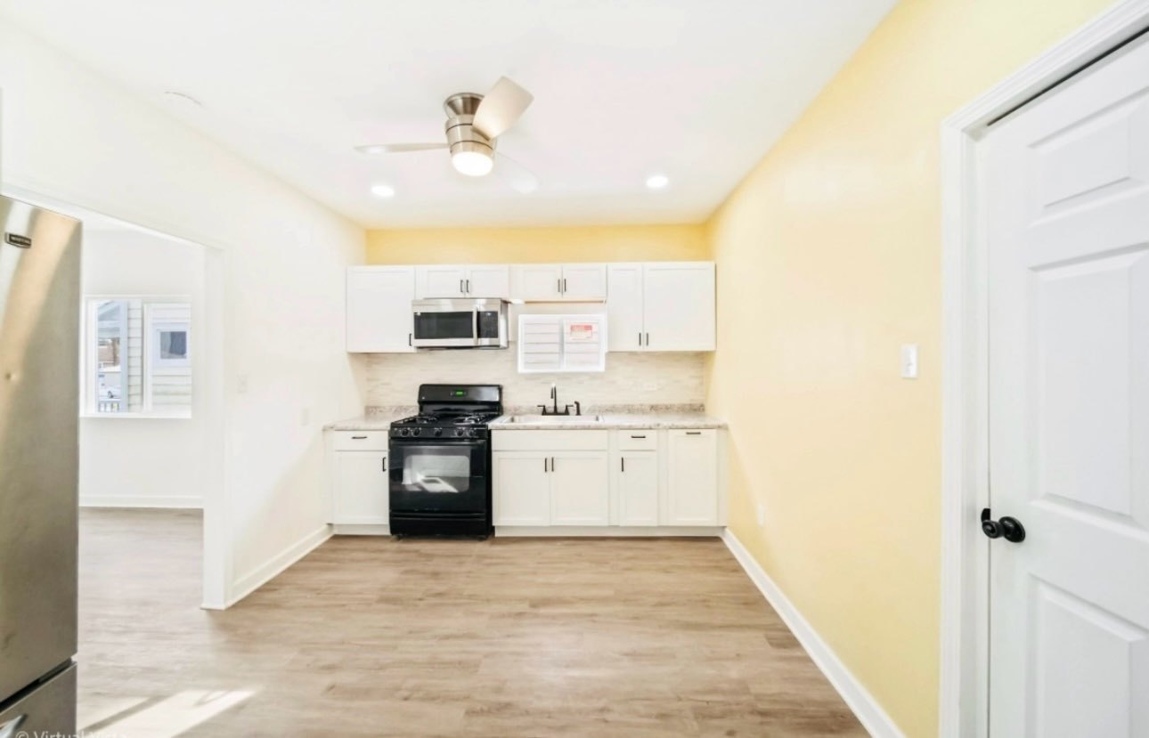 1216 Park Avenue, Unit 1 Chicago Heights, IL 60411 - Photo 7 of 10 a kitchen with a refrigerator and a stove