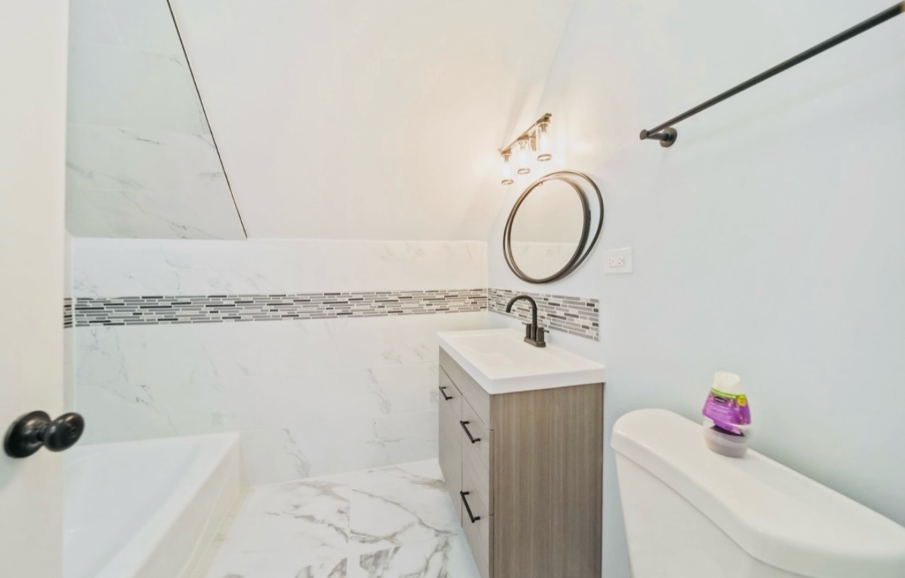1216 Park Avenue, Unit 1 Chicago Heights, IL 60411 - Photo 10 of 10 a bathroom with a sink and a mirror