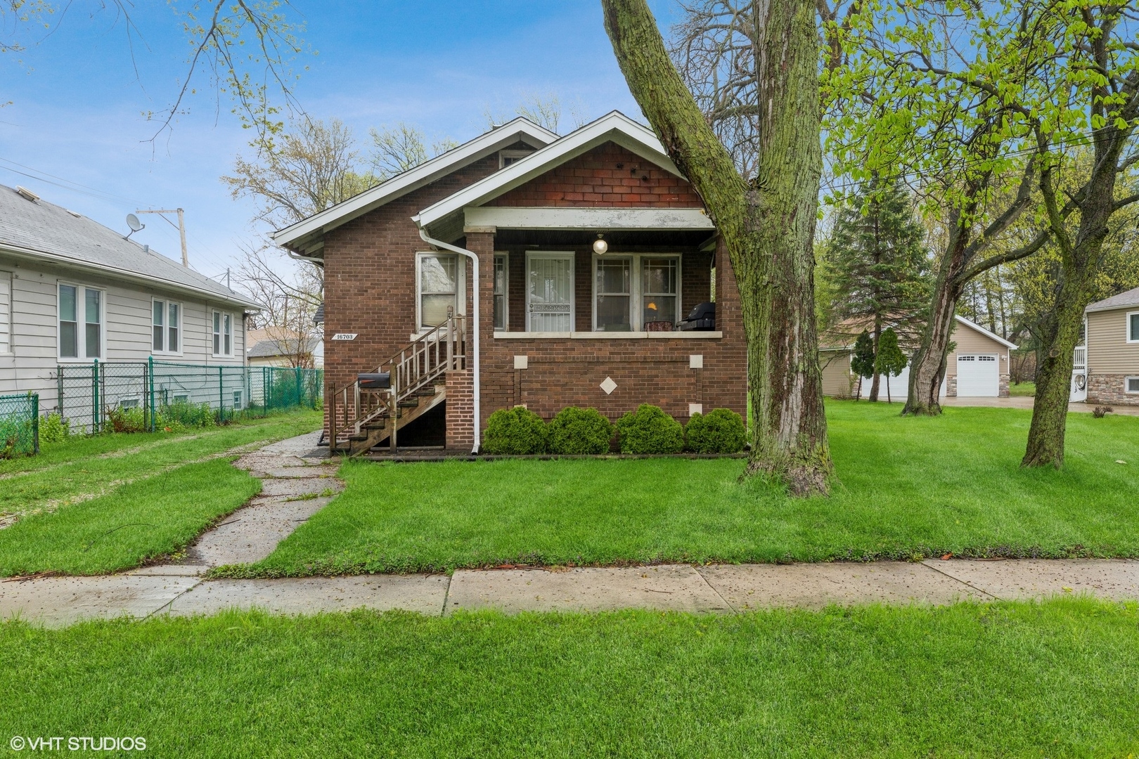 16703 Lincoln Street Hazel Crest, IL 60429 - Photo 1 of 16 a front view of a house with a garden