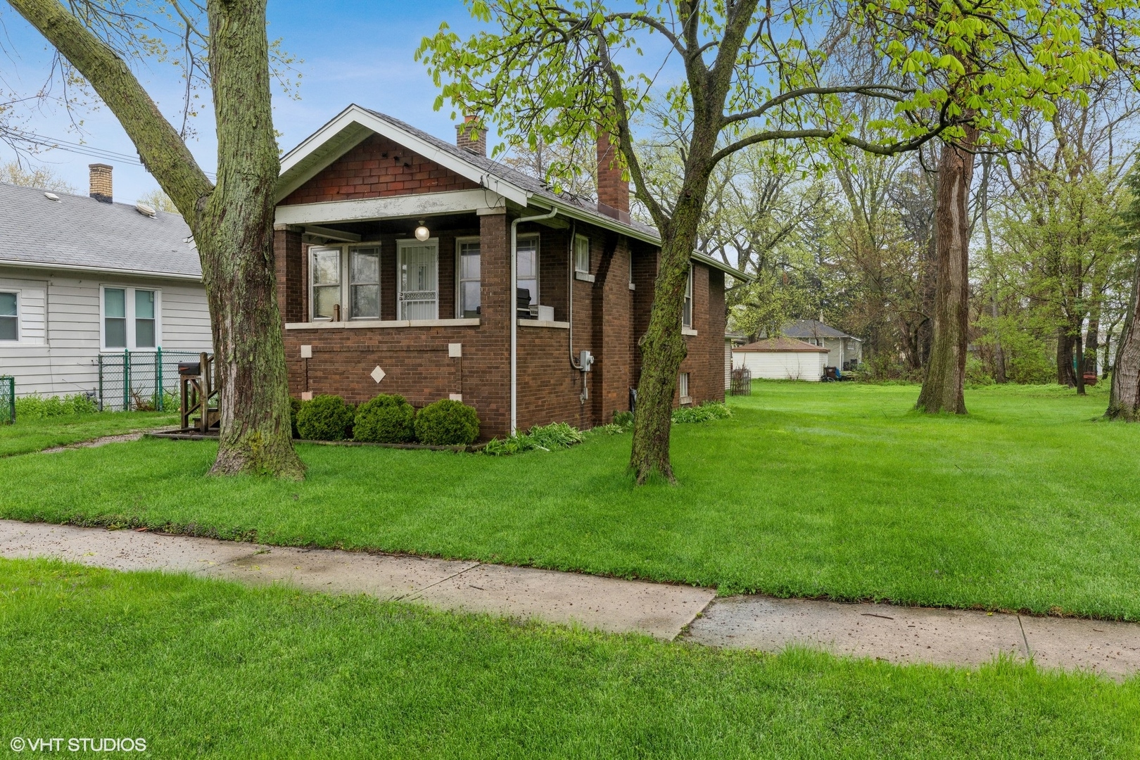 16703 Lincoln Street Hazel Crest, IL 60429 - Photo 2 of 16 a front view of a house with a garden