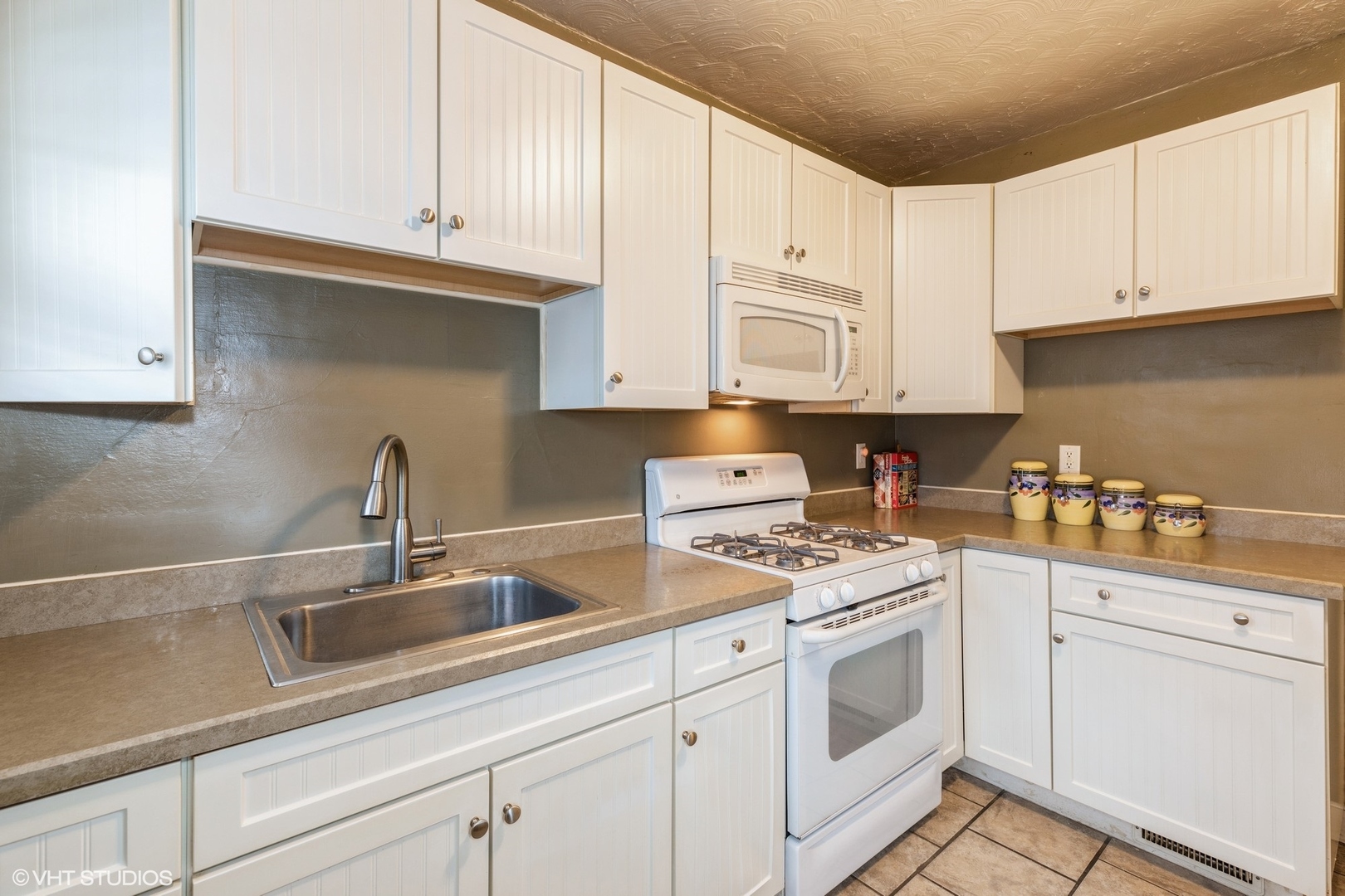16703 Lincoln Street Hazel Crest, IL 60429 - Photo 7 of 16 a kitchen with white cabinets and white appliances