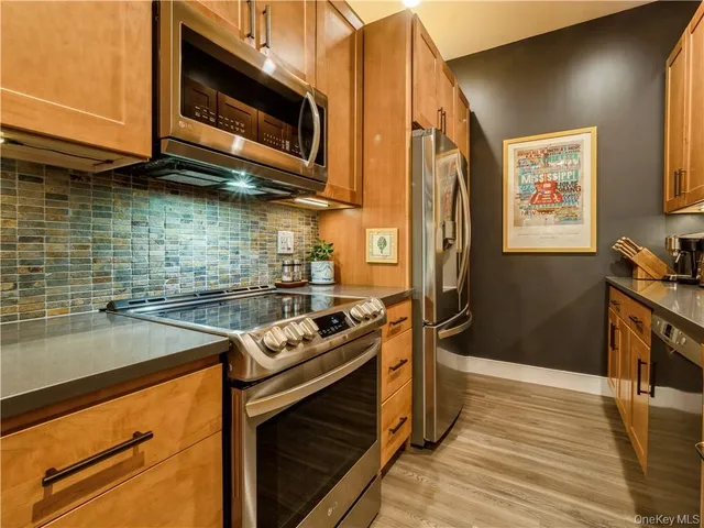 a kitchen with a stove microwave and sink