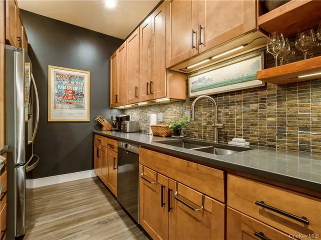 a kitchen with stainless steel appliances a sink stove and refrigerator