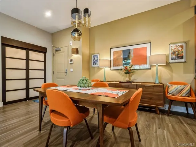 a view of a dining room with furniture and wooden floor