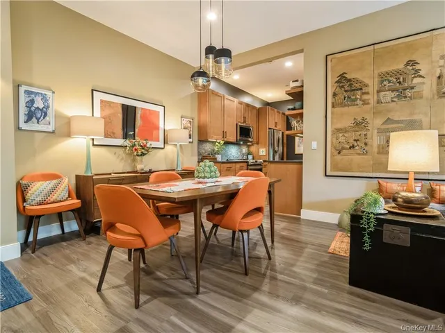 a dining room with furniture a rug and wooden floor