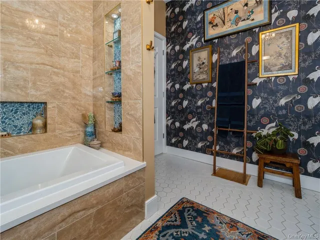 a bathroom with a bathtub and shower