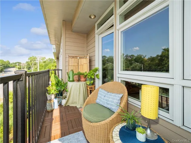 a view of a porch with furniture and a potted plant