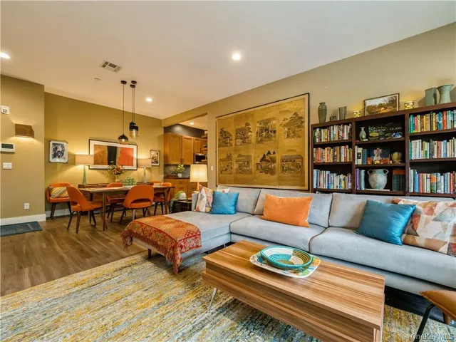 a living room with furniture and book shelf