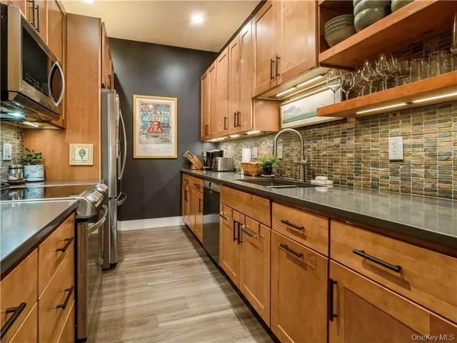 a kitchen with stainless steel appliances a sink and cabinets