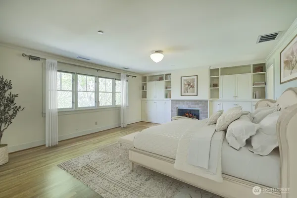 a bedroom with a large bed and a window