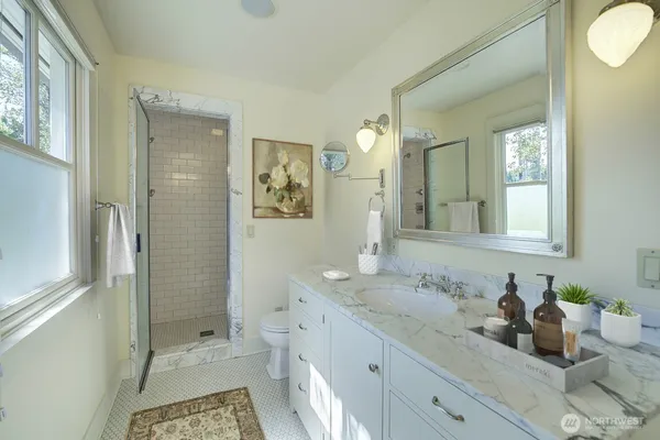 a bathroom with a granite countertop sink mirror and double