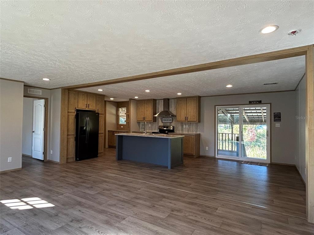 6443 Finance Avenue Weeki Wachee, FL 34607 - Photo 13 of 45 a large space with a large window and wooden floor