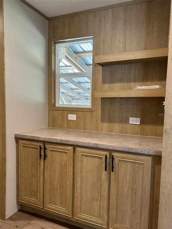 6443 Finance Avenue Weeki Wachee, FL 34607 - Photo 16 of 45 a sink with granite countertop cabinets