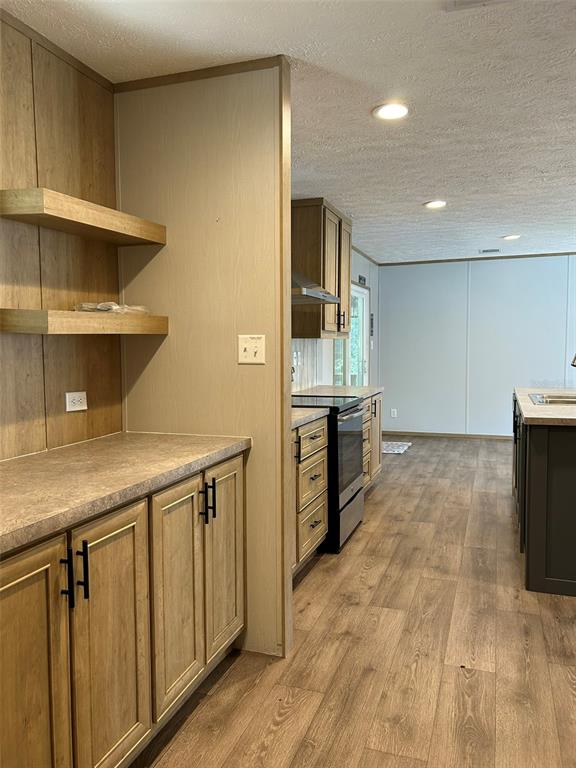 6443 Finance Avenue Weeki Wachee, FL 34607 - Photo 17 of 45 a kitchen with stainless steel appliances granite countertop a sink and cabinets