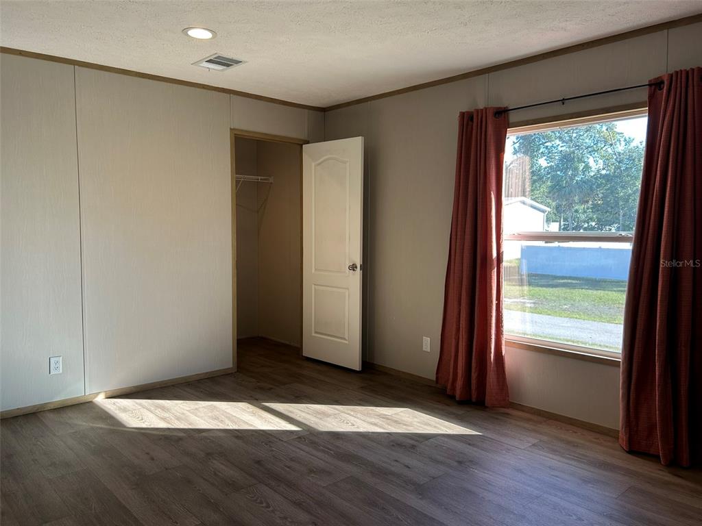 6443 Finance Avenue Weeki Wachee, FL 34607 - Photo 20 of 45 an empty room with wooden floor and windows