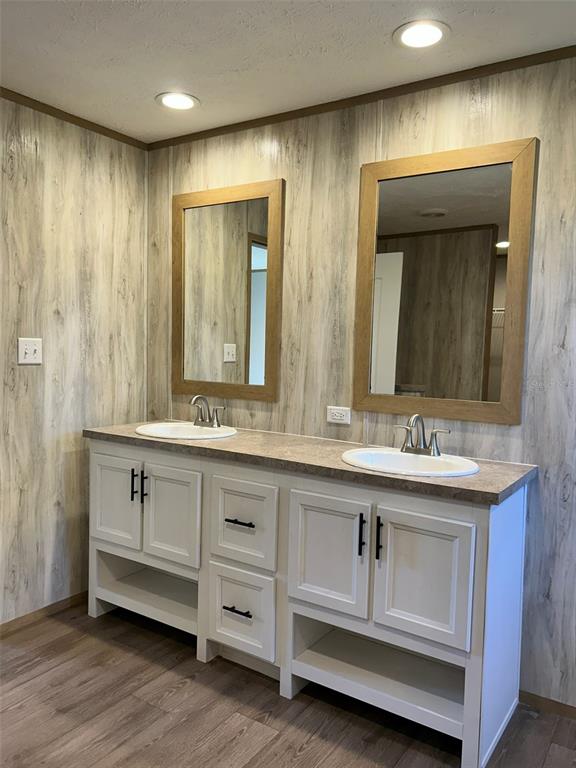 6443 Finance Avenue Weeki Wachee, FL 34607 - Photo 22 of 45 a bathroom with a double vanity sink and a mirror