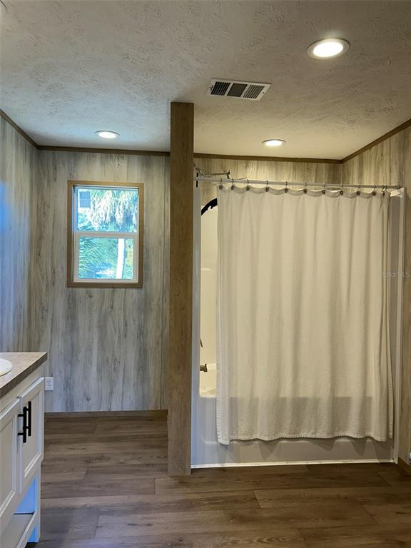 6443 Finance Avenue Weeki Wachee, FL 34607 - Photo 23 of 45 a view of a livingroom with wooden floor and a window