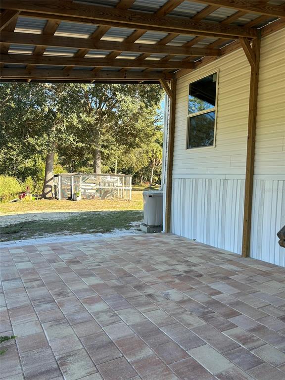 6443 Finance Avenue Weeki Wachee, FL 34607 - Photo 33 of 45 a view of porch with a yard