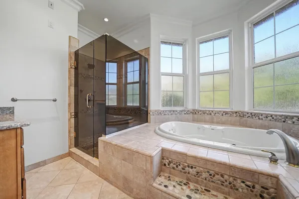 a bathroom with a bathtub and a shower