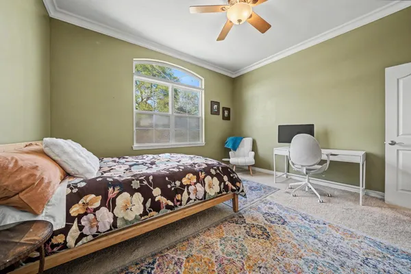 a bedroom with a bed and window