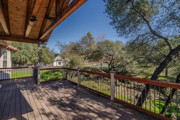 a view of a balcony with wooden fence