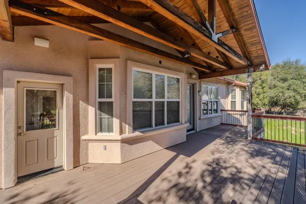 a view of a house with a wooden deck