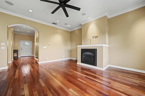 a view of a livingroom with a fireplace and wooden floor