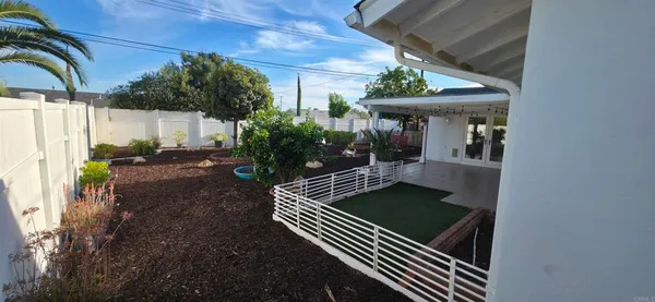 a backyard of a house with outdoor seating