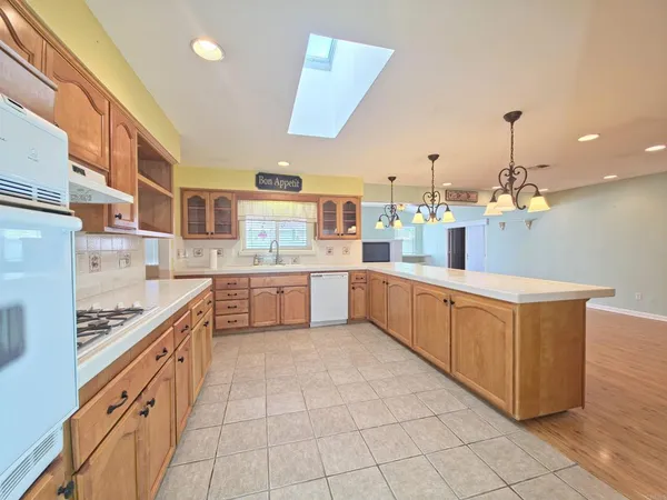 a large kitchen with stainless steel appliances lots of counter top space