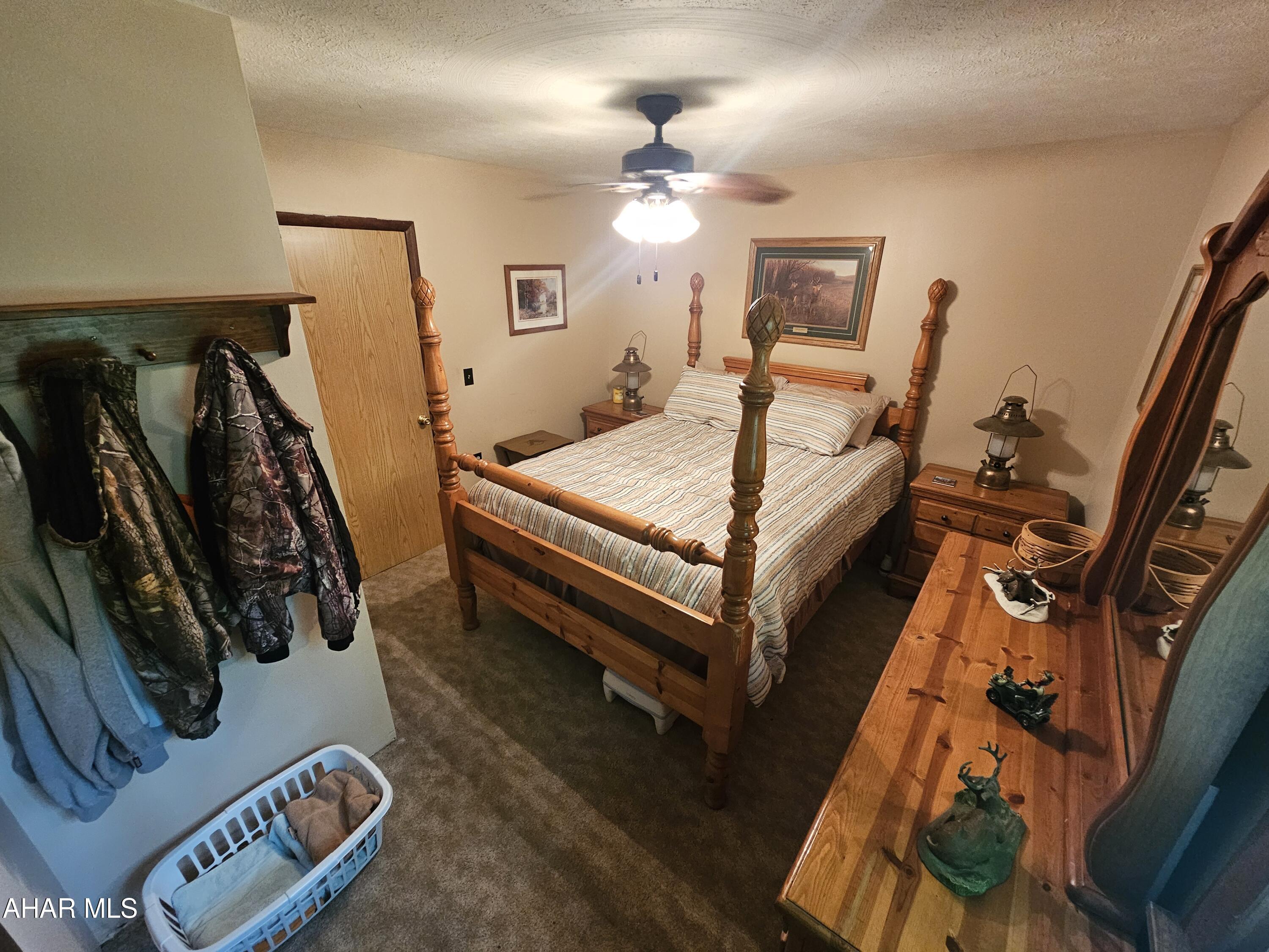 207 Kendrick Lane Flinton, PA 16640 - Photo 15 of 30 a bedroom with a bed and a chandelier