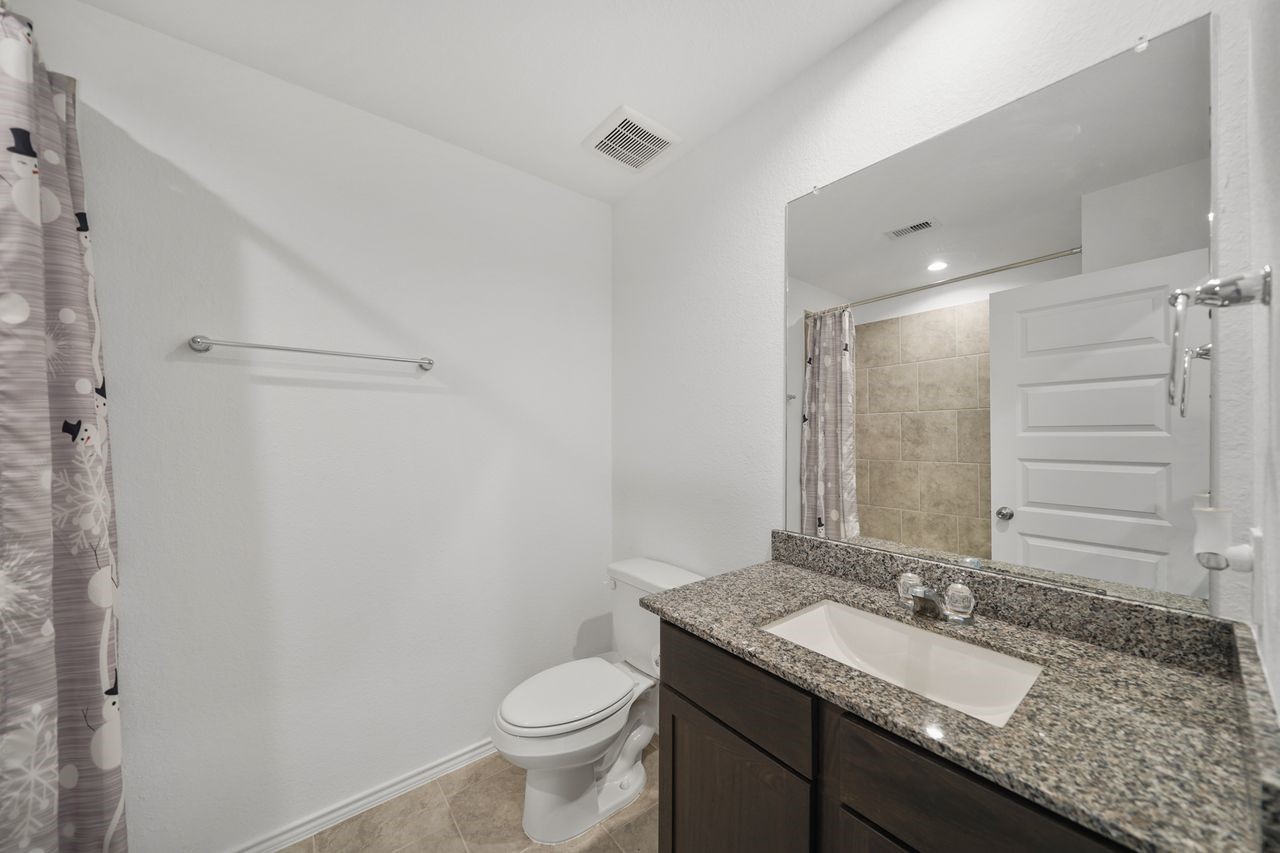 7502 Fierce Friesian Lane Rosharon, TX 77583 - Photo 14 of 21 a bathroom with a granite countertop sink toilet and mirror