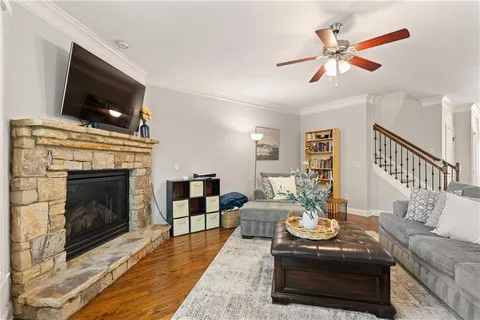 a living room with furniture a flat screen tv and a fireplace