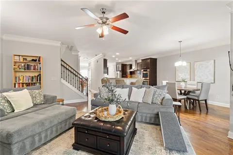 a living room with furniture and wooden floor