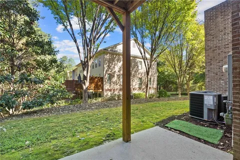a view of a backyard with large trees