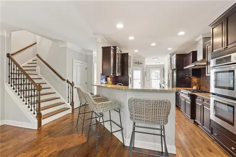 a view of a kitchen with furniture and wooden floor