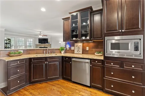 a kitchen with stainless steel appliances granite countertop cabinets and window