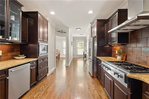 a kitchen with stainless steel appliances granite countertop a stove and a refrigerator