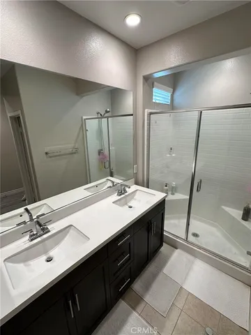 a bathroom with a double vanity sink mirror and double